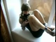 Cuffed and gagged in front of window