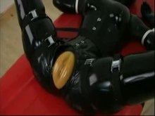 Rubber slave taken to cum