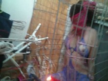 Caged slave girl getting hot wax