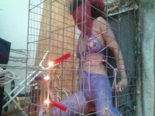 Caged slave girl getting hot wax