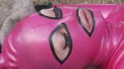 Latex slave suspended for blowjob