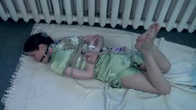 Hogtied and gagged brunette struggling on the floor