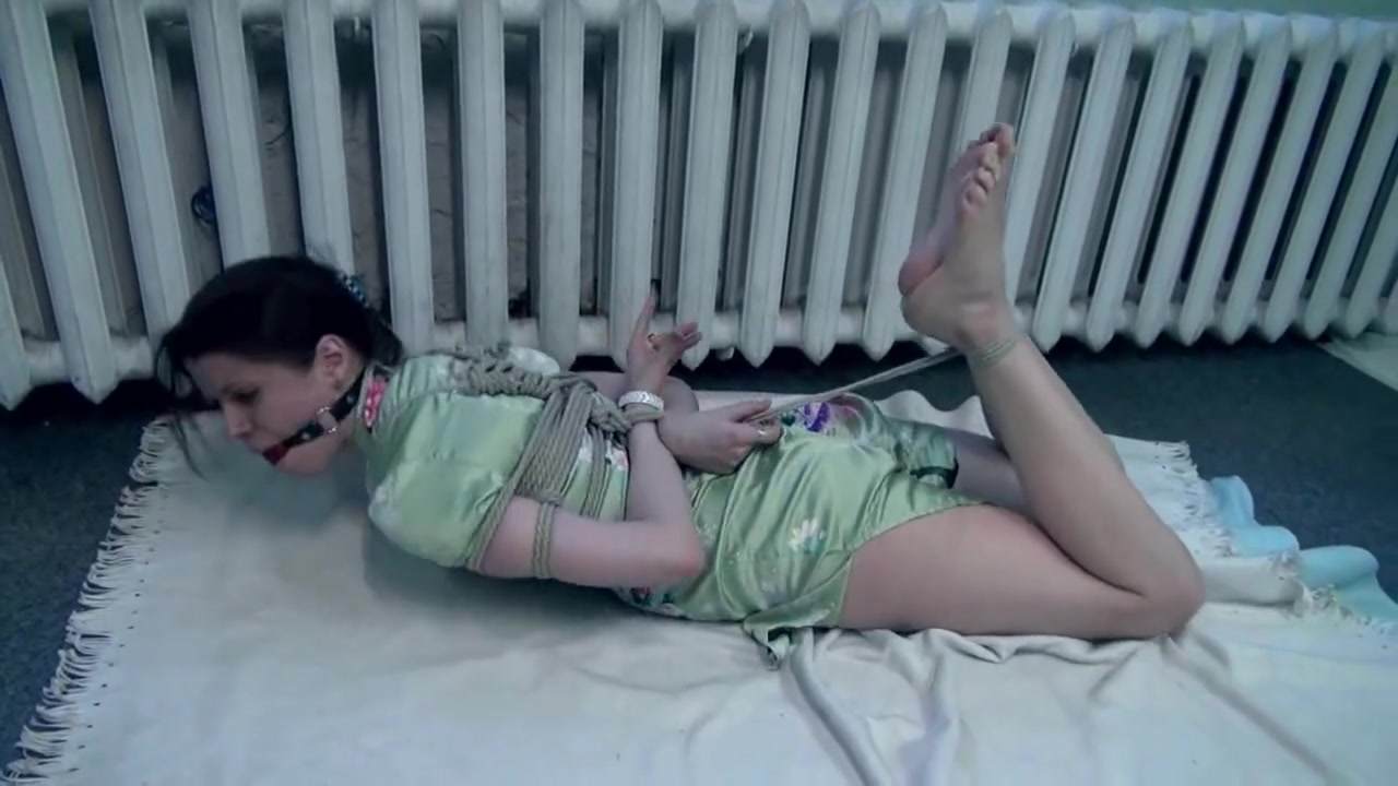 Hogtied and gagged brunette struggling on the floor
