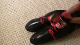 Hogtied in red ropes and latex