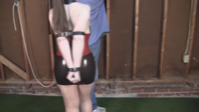 Liz Andrews in latex and belt restraints