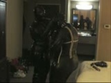 Two Girls in Rubber Wearing Gas Masks