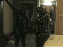 Two Girls in Rubber Wearing Gas Masks